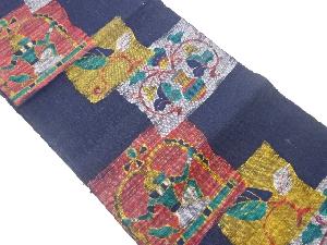 手織り真綿紬色紙にエジプト人物・草花模様織出し名古屋帯